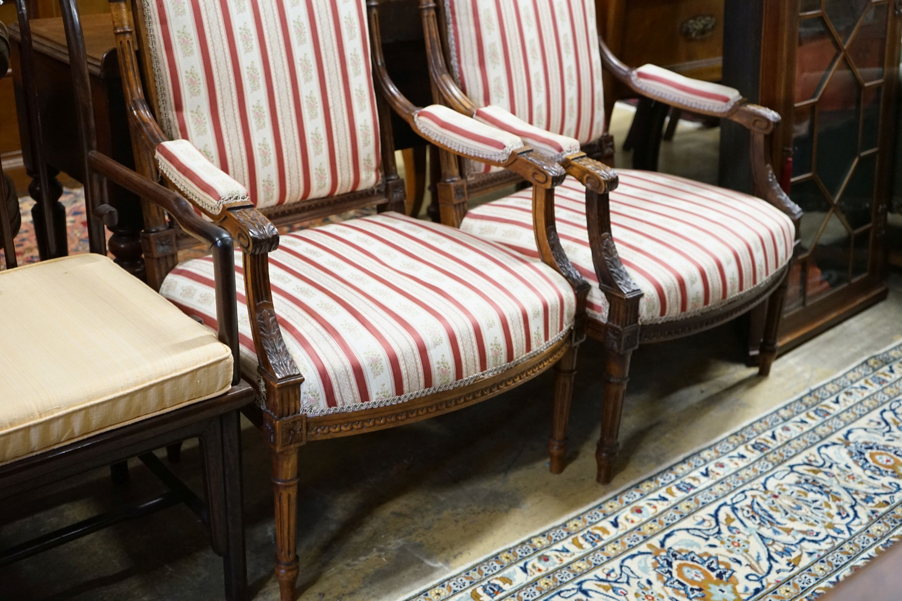 A pair of 19th century French carved walnut elbow chairs, width 61cm, depth 58cm, height 96cm